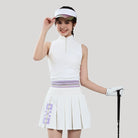 Woman in golf attire with a white outfit and visor on a plain background