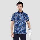 Man wearing a blue patterned shirt and black pants on a gray background