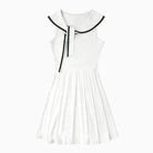 White dress with black trim on a white background