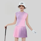 Woman in a gradient dress holding a golf club on a plain background