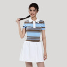 Woman wearing a striped dress with a white collar against a plain background