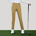 Person wearing tan golf pants with a golf club on a green and beige background